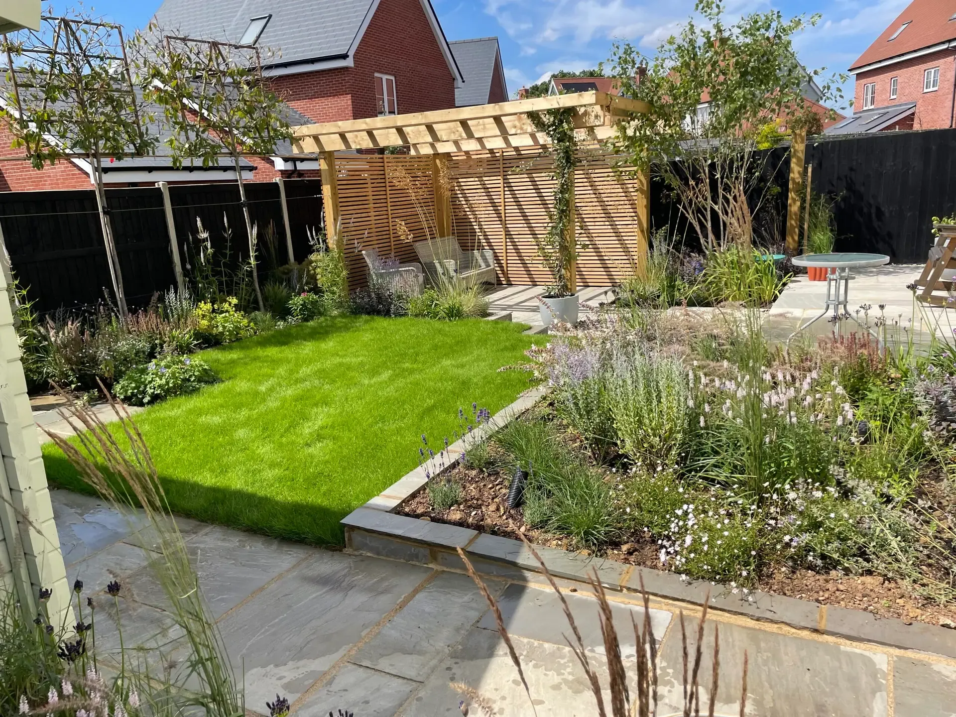 Feature tree planting adding height and structure in Beaulieu garden