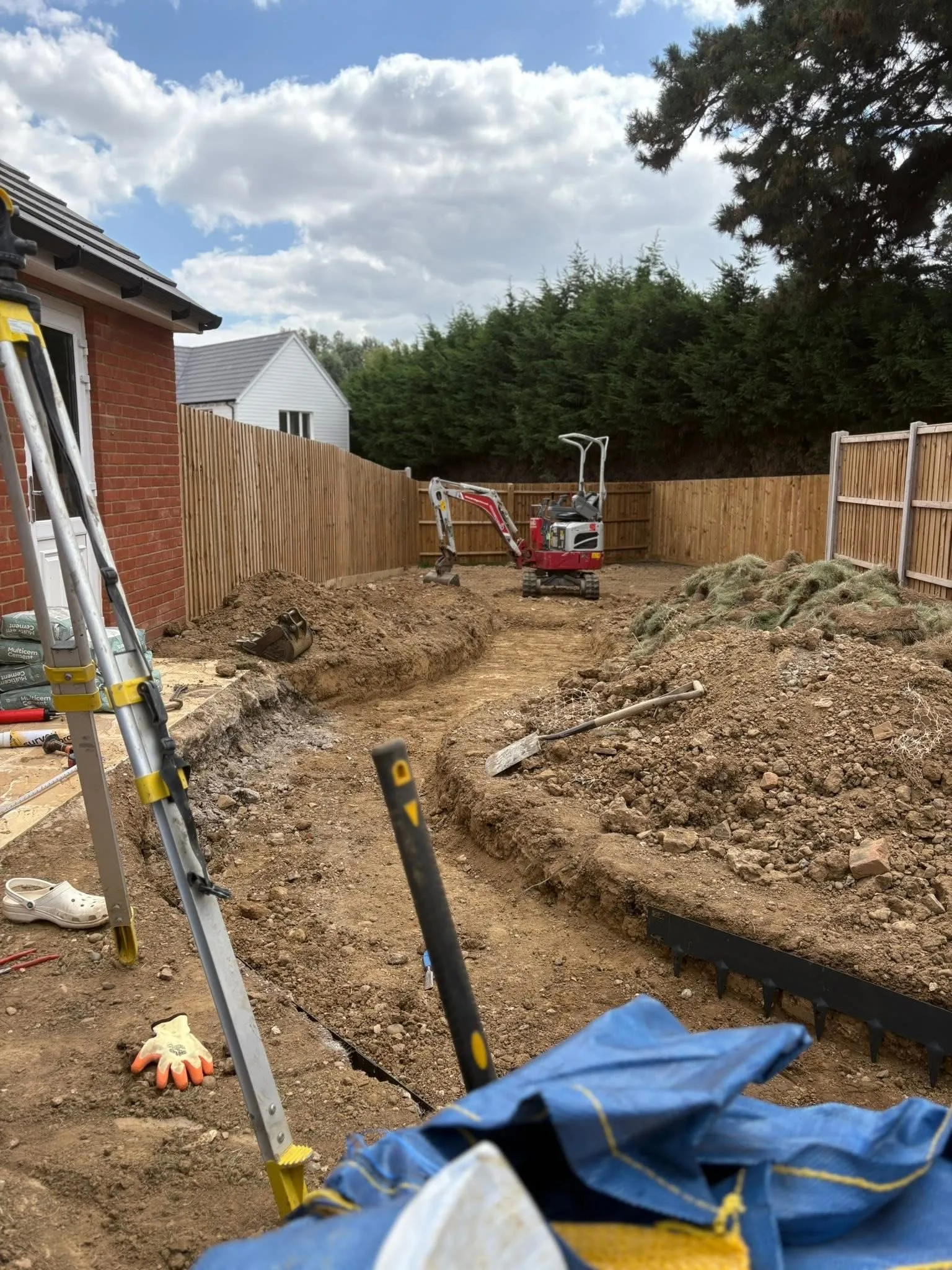 Long view of Kelvedon garden showing curved layout and softened fencing